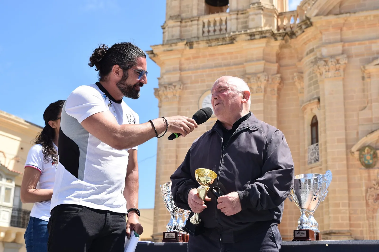 Fr. Anton Refalo speaking at a prize-giving in Xagħra Square