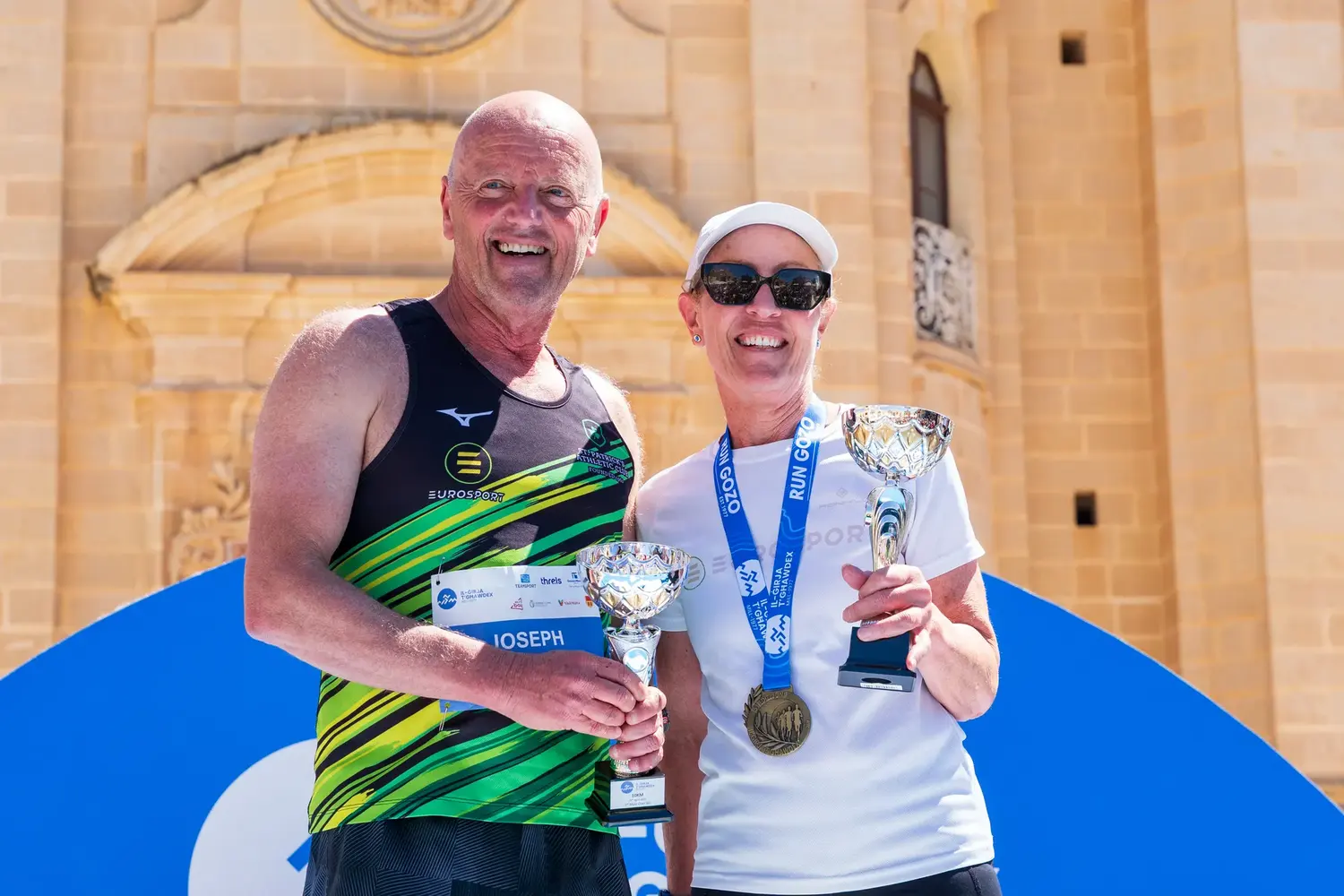 Two prize-winners with their trophies on the podium